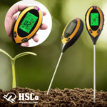 Soil meter pushed into the soil beside a seedling