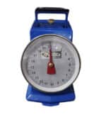 HSCo mechanical infant weighing scale close-up showing the numbered dial, red pointer and blue base