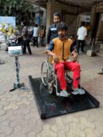Patient seated in a wheelchair on the HSCo wheelchair scale
