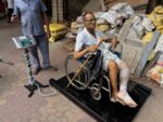 Patient with a bandaged leg weighed in a wheelchair on the scale