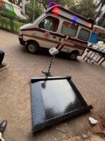 Wheelchair scale platform with ramps beside an ambulance