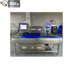 Checkweigher line with touch screen and label printer in a factory