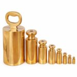 HSCo brass bottle weights in graduated sizes, with polished cylindrical bodies and a loop handle on the largest weight