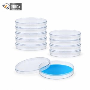 Stacks of clear sterile plastic Petri dishes, one with blue culture medium