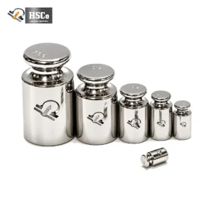 Row of stainless steel calibration weights from large to small, HSCo emblem