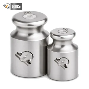 Two stainless steel calibration weights etched with the HSCo emblem