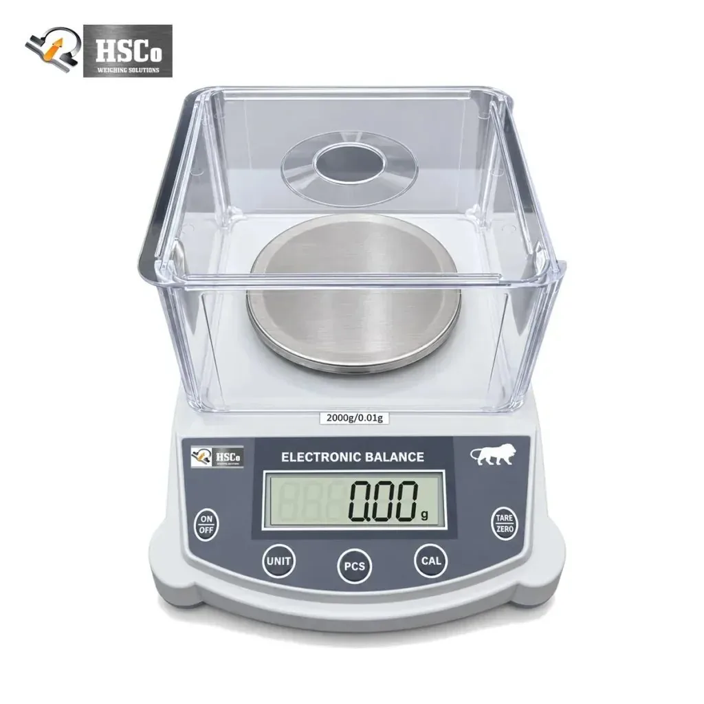 HSCo JEWE2000 jewellery scale with a clear draft shield over a round stainless steel pan