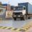 Illustration: truck carrying a 20-foot container on a flat-deck weighbridge at an inland container depot