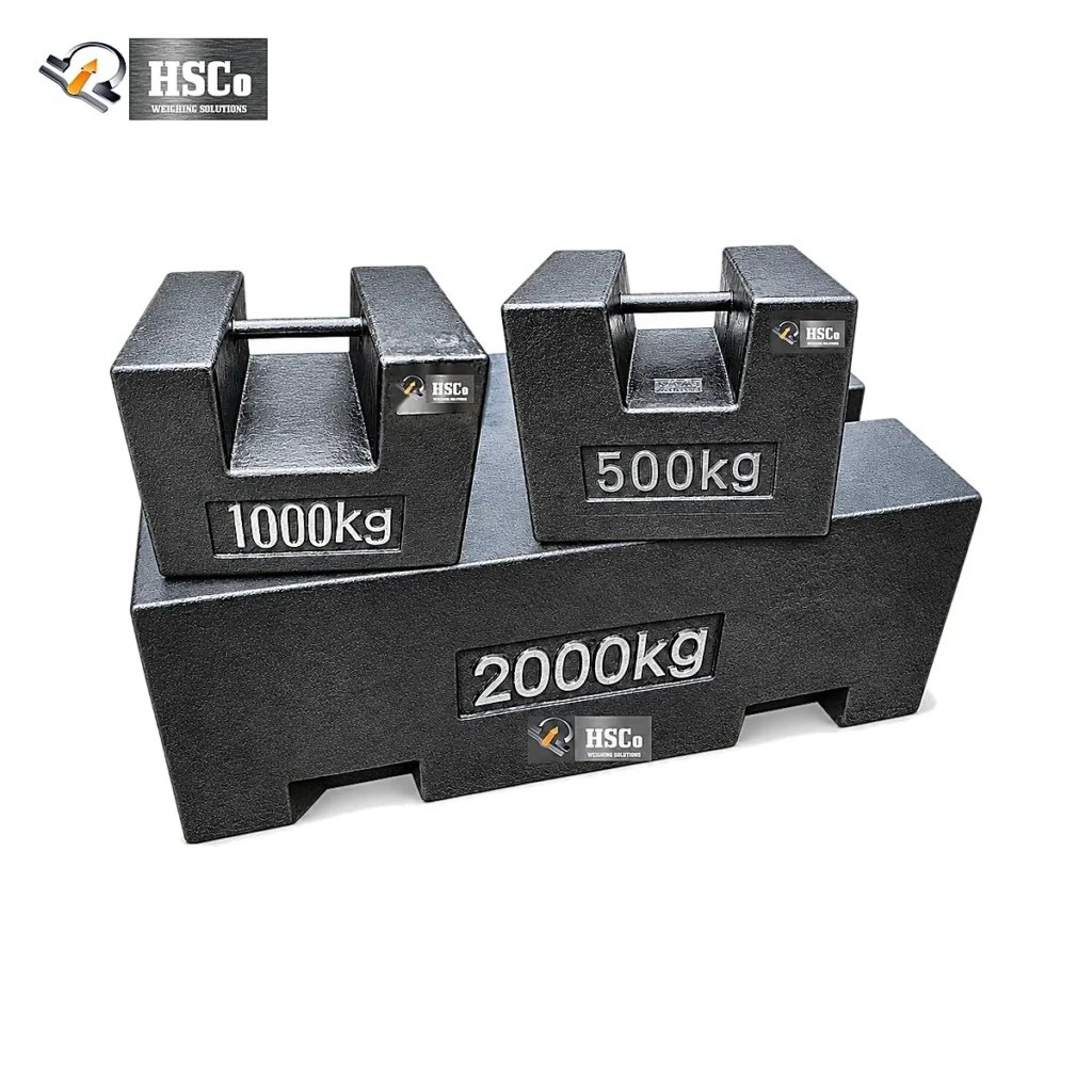 Weighbridge weight difference: comparing the error limits of two weighbridges 9 HSCo cast iron test weights of 500 kg, 1,000 kg and 2,000 kg stacked as black blocks